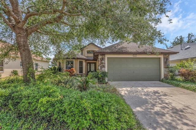 8167 Bridgeport Bay Cir, Mount Dora, FL 32757 - view of front of home with stone siding, driveway, and a garage