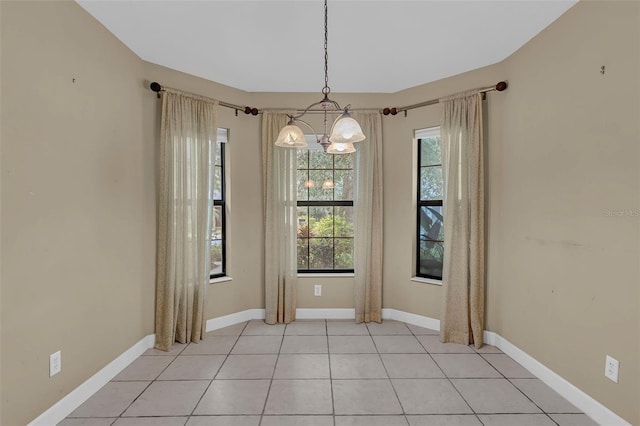 8167 Bridgeport Bay Cir, Mount Dora, FL 32757 - unfurnished dining area featuring a chandelier, light tile patterned floors, and baseboards