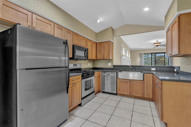 8167 Bridgeport Bay Cir, Mount Dora, FL 32757 - kitchen featuring appliances with stainless steel finishes, a sink, dark countertops, lofted ceiling, and ceiling fan