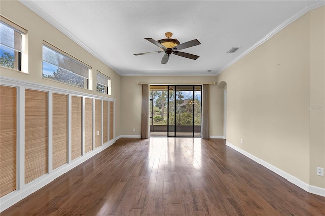 8167 Bridgeport Bay Cir, Mount Dora, FL 32757 - unfurnished room with ceiling fan, arched walkways, baseboards, ornamental molding, and dark wood-type flooring