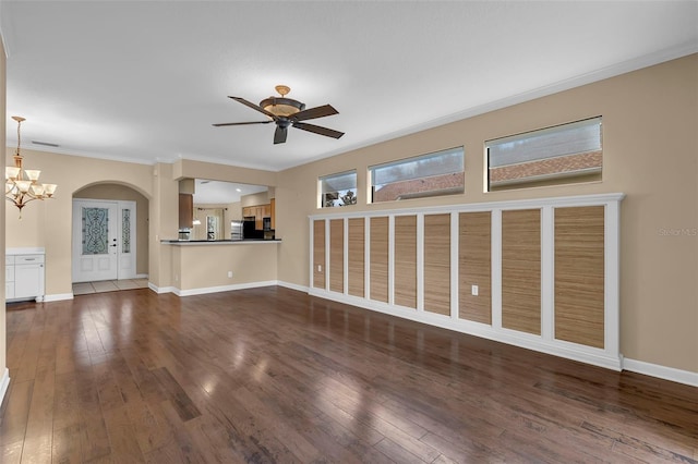 8167 Bridgeport Bay Cir, Mount Dora, FL 32757 - unfurnished living room featuring hardwood / wood-style flooring, arched walkways, crown molding, ceiling fan, and baseboards
