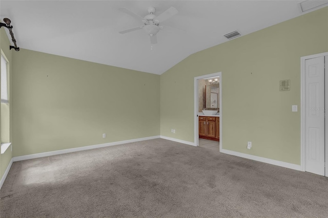 8167 Bridgeport Bay Cir, Mount Dora, FL 32757 - unfurnished bedroom featuring vaulted ceiling, carpet flooring, baseboards, ensuite bathroom, and ceiling fan