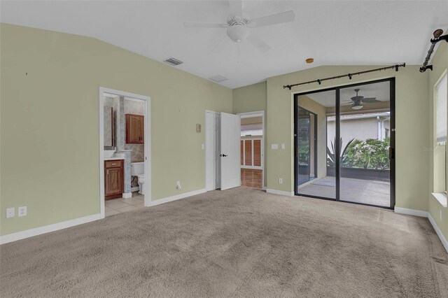 8167 Bridgeport Bay Cir, Mount Dora, FL 32757 - unfurnished bedroom with access to exterior, light carpet, lofted ceiling, baseboards, and ensuite bathroom