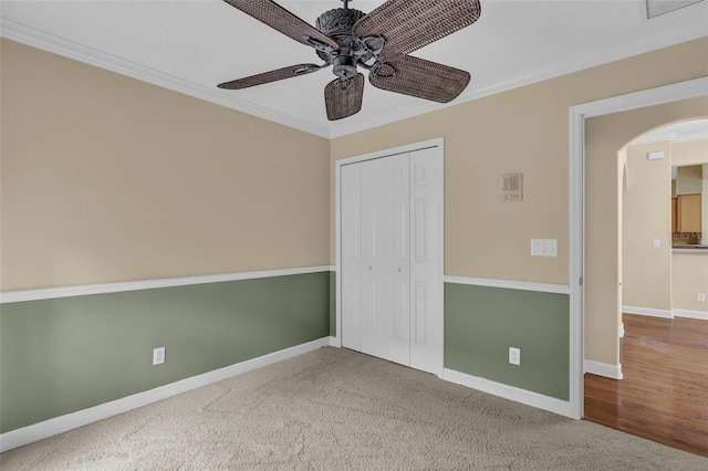 8167 Bridgeport Bay Cir, Mount Dora, FL 32757 - unfurnished bedroom featuring arched walkways, ornamental molding, a closet, baseboards, and a ceiling fan