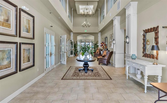 8167 Bridgeport Bay Cir, Mount Dora, FL 32757 - entryway with a towering ceiling, baseboards, a chandelier, and french doors