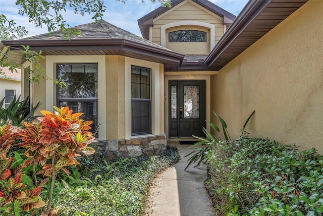 8167 Bridgeport Bay Cir, Mount Dora, FL 32757 - view of exterior entry featuring stone siding and stucco siding