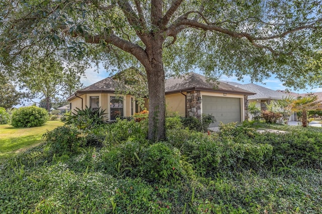 8167 Bridgeport Bay Cir, Mount Dora, FL 32757 - view of front of home with an attached garage and stone siding