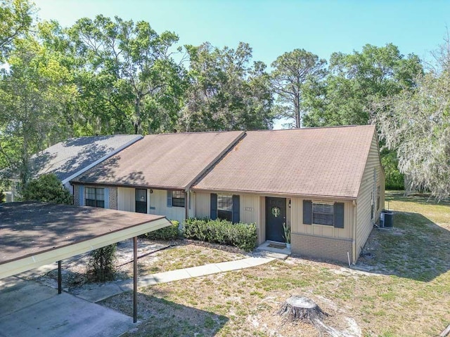 ranch-style home with central AC and a front yard