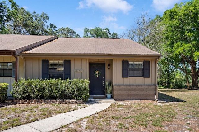 view of front of property featuring brick siding and board and batten siding