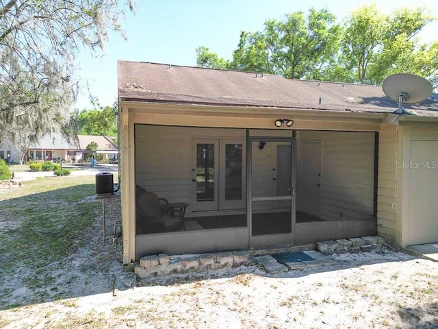 back of property with a sunroom