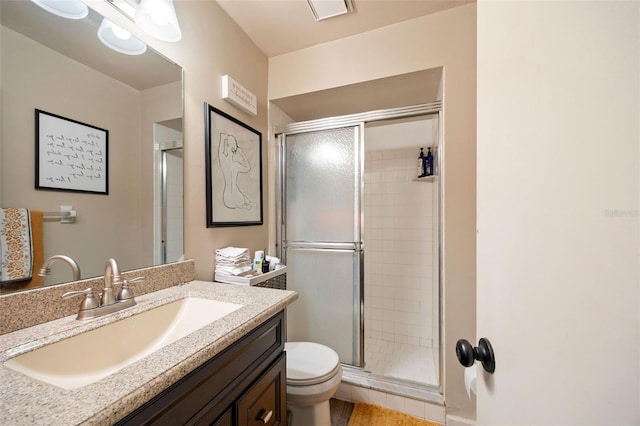 full bath featuring toilet, visible vents, a shower stall, and vanity