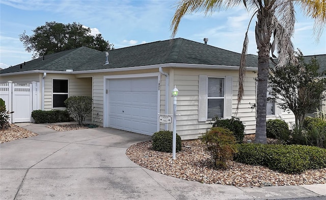 1482 Azteca Loop, The Villages, FL 32162 - view of side of property with fence, an attached garage, a shingled roof, and driveway