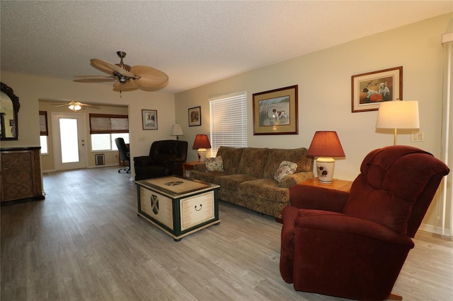 1482 Azteca Loop, The Villages, FL 32162 - living area featuring light wood-type flooring, a ceiling fan, and a textured ceiling
