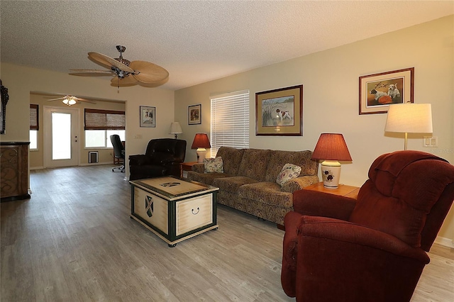 1482 Azteca Loop, The Villages, FL 32162 - living area featuring ceiling fan, a textured ceiling, and light wood-style floors
