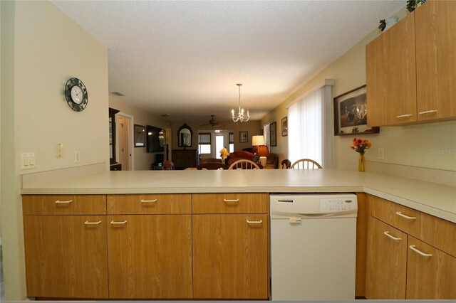 1482 Azteca Loop, The Villages, FL 32162 - kitchen with a peninsula, light countertops, open floor plan, and white dishwasher