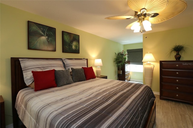 1482 Azteca Loop, The Villages, FL 32162 - bedroom featuring baseboards, a ceiling fan, and wood finished floors