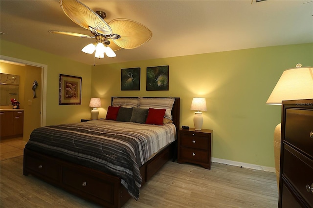 1482 Azteca Loop, The Villages, FL 32162 - bedroom with baseboards, ceiling fan, and light wood-type flooring