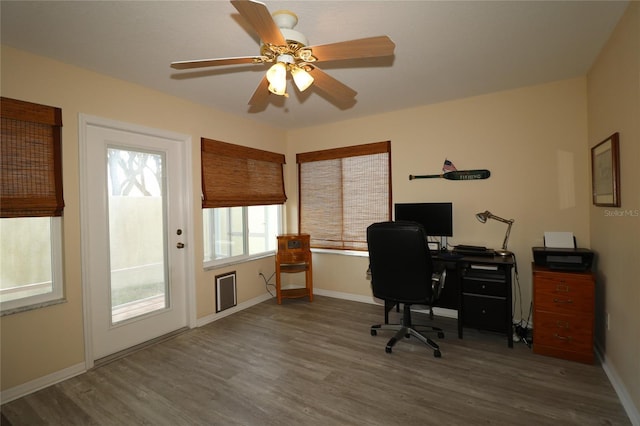 1482 Azteca Loop, The Villages, FL 32162 - home office with baseboards, ceiling fan, and wood finished floors