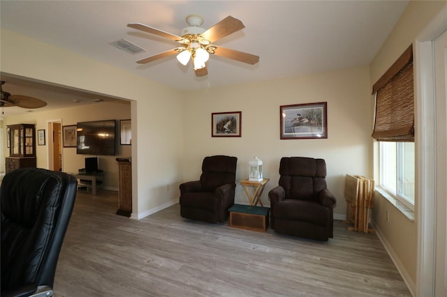1482 Azteca Loop, The Villages, FL 32162 - living area featuring baseboards, wood finished floors, a ceiling fan, and visible vents