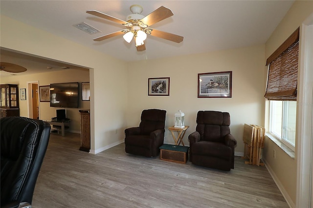 1482 Azteca Loop, The Villages, FL 32162 - living area with ceiling fan, baseboards, visible vents, and wood finished floors