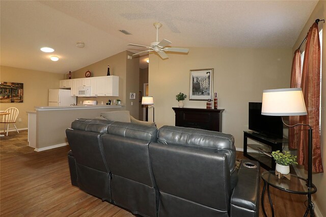 1070 Pinewood Pl, The Villages, FL 32162 - living area with ceiling fan, wood finished floors, lofted ceiling, and baseboards