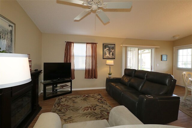 1070 Pinewood Pl, The Villages, FL 32162 - living room with wood finished floors, ceiling fan, baseboards, and vaulted ceiling