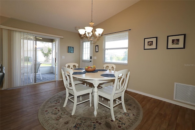 1070 Pinewood Pl, The Villages, FL 32162 - dining room featuring a chandelier, dark wood-type flooring, vaulted ceiling, and baseboards