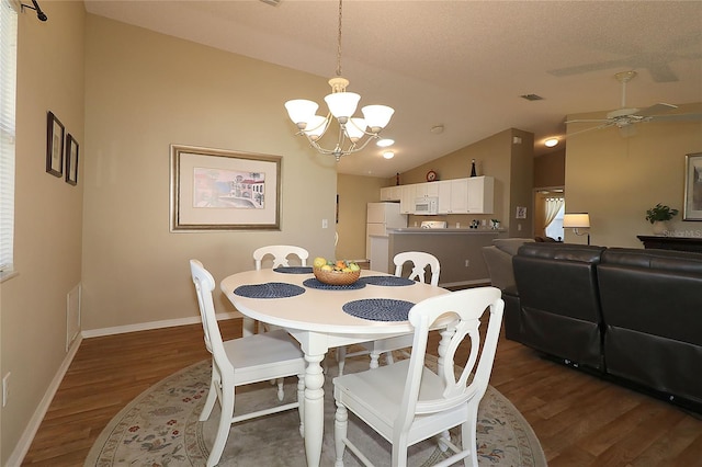1070 Pinewood Pl, The Villages, FL 32162 - dining area with wood finished floors, a chandelier, lofted ceiling, baseboards, and ceiling fan