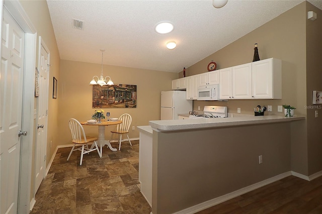 1070 Pinewood Pl, The Villages, FL 32162 - kitchen with white appliances, baseboards, light countertops, a peninsula, and a chandelier