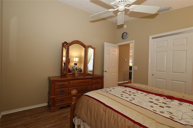 1070 Pinewood Pl, The Villages, FL 32162 - bedroom featuring dark wood finished floors, baseboards, and a ceiling fan
