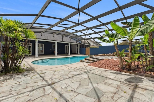 view of swimming pool featuring glass enclosure, a fenced in pool, french doors, and a patio area