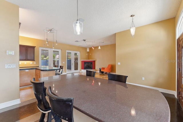 kitchen with baseboards, pendant lighting, and rail lighting
