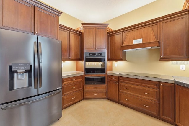 kitchen featuring brown cabinetry, oven, stainless steel refrigerator with ice dispenser, cooktop, and a warming drawer