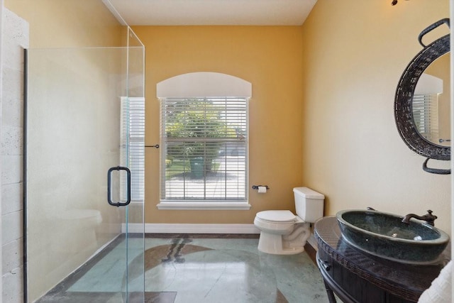 full bath featuring baseboards, a stall shower, toilet, and vanity