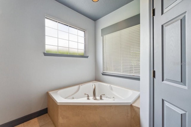 full bathroom featuring a whirlpool tub, tile patterned floors, and baseboards