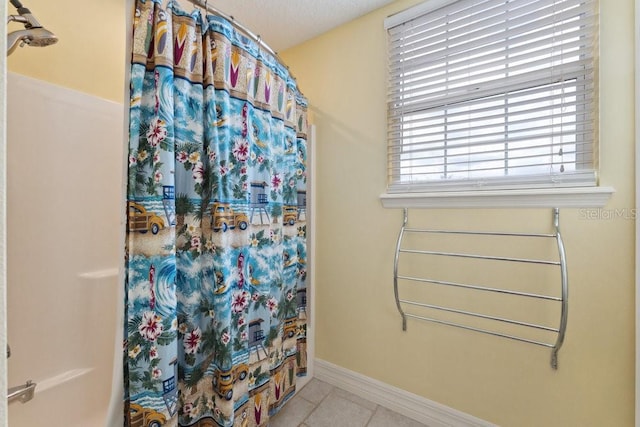 full bath with tile patterned floors, baseboards, and a shower with shower curtain