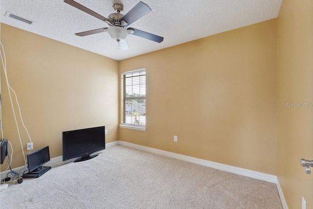 unfurnished room with visible vents, a textured ceiling, carpet, and ceiling fan