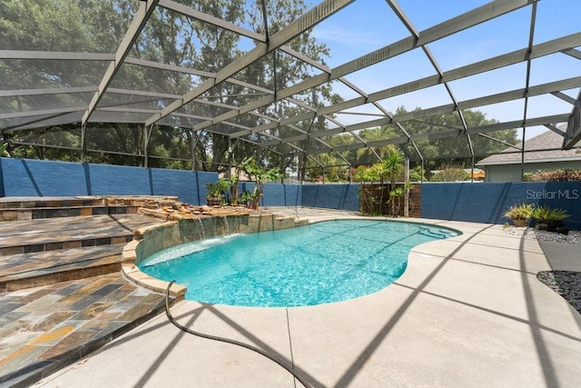 view of swimming pool with a fenced in pool, fence, glass enclosure, and a patio area