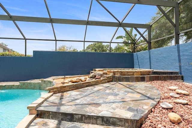 view of swimming pool with a fenced in pool and a lanai