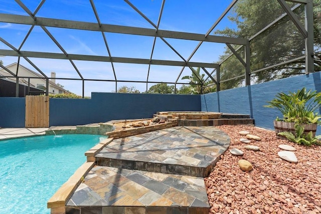 view of swimming pool featuring a fenced in pool and glass enclosure