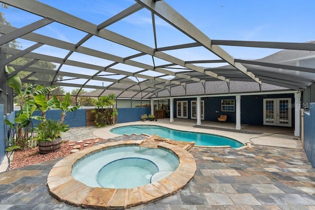 view of pool featuring an in ground hot tub, a lanai, french doors, a fenced in pool, and a patio