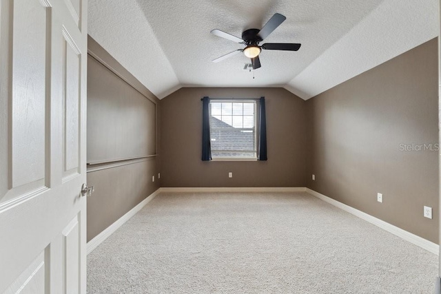 bonus room with carpet floors, a ceiling fan, a textured ceiling, and vaulted ceiling