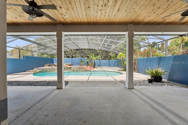 view of swimming pool featuring a jacuzzi, a fenced backyard, a fenced in pool, a patio area, and a ceiling fan