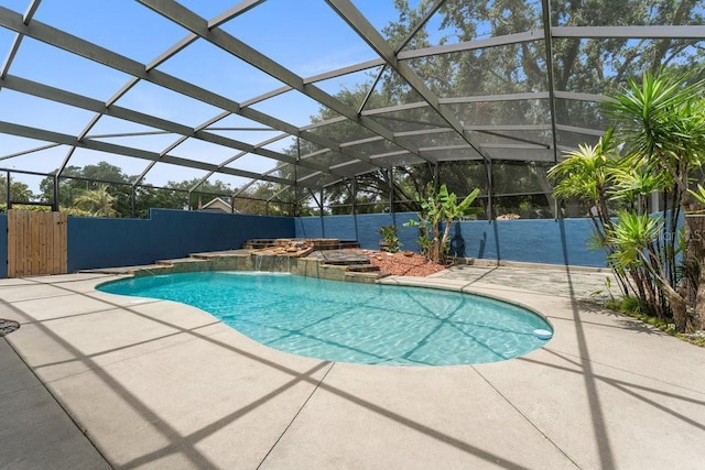 view of swimming pool with a fenced in pool, glass enclosure, a hot tub, and a patio area