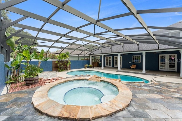 view of pool featuring fence, a patio, french doors, glass enclosure, and a pool with connected hot tub