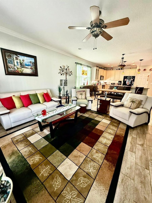 1231 Merion Dr, Mount Dora, FL 32757 - living room featuring ceiling fan, crown molding, and light wood-style flooring