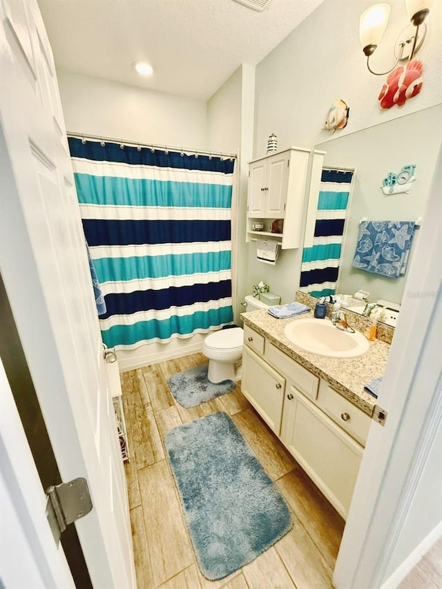 1231 Merion Dr, Mount Dora, FL 32757 - bathroom featuring vanity, wood finished floors, toilet, and a shower with curtain