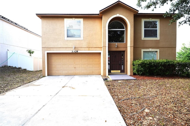 3329 White Blossom Ln, Clermont, FL 34711 - view of front facade featuring stucco siding, an attached garage, and driveway