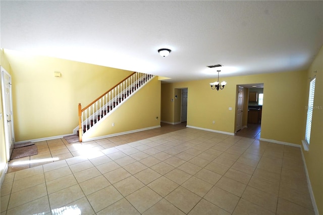 3329 White Blossom Ln, Clermont, FL 34711 - unfurnished living room featuring a chandelier, tile patterned flooring, stairs, and baseboards