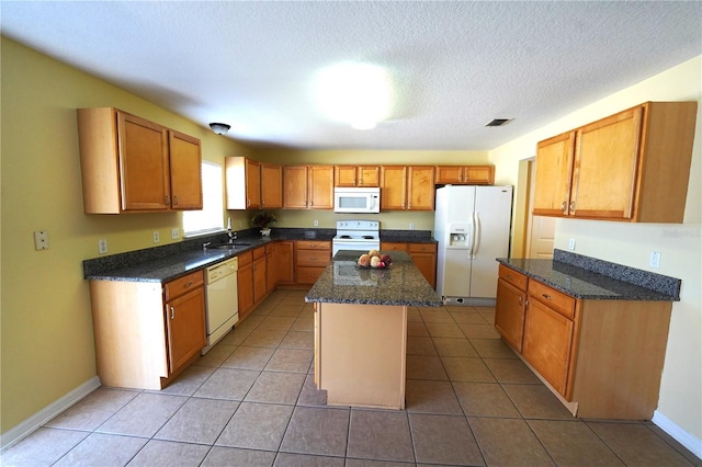 3329 White Blossom Ln, Clermont, FL 34711 - kitchen featuring white appliances, a sink, a kitchen island, dark stone countertops, and light tile patterned floors